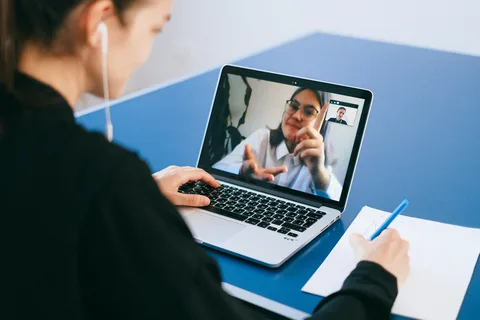 Teacher conducting an online tuition session from home, showcasing the flexibility of online tuition jobs and connecting with students globally.